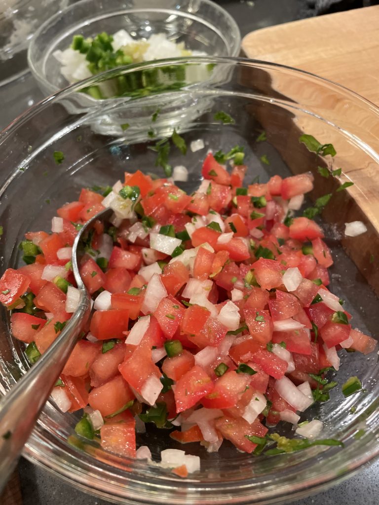 pico de gallo in a bowl with a spoon at an Eastside Seattle day date at Whisk cooking class